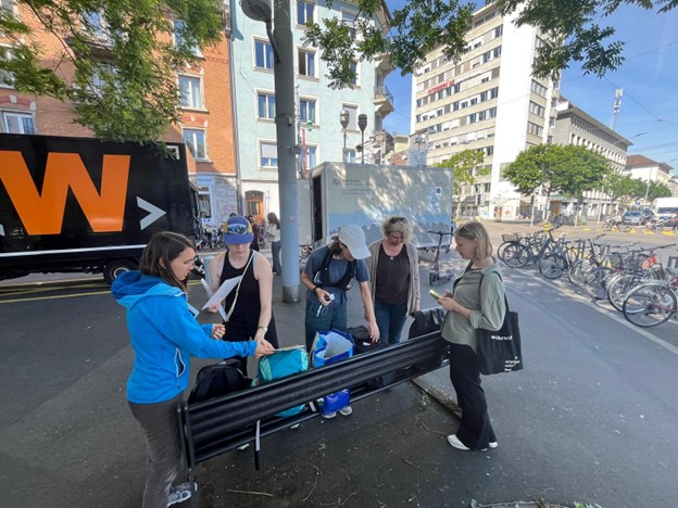 Larissa Hänsli, Sierra Arn, Noemie Marti, Barbara Bichsel von Arb, and Carine Biwer preparing the needed equipment for the walking circuits in Wiedikon.
